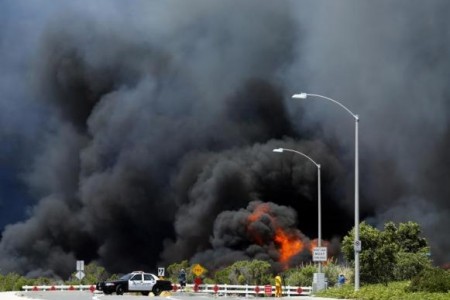 A wildfire burns through a canyon in Carlsbad, May 14, 2014.