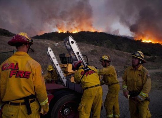 Firefighters battle a blaze in San Marcos, California May 14, 2014.